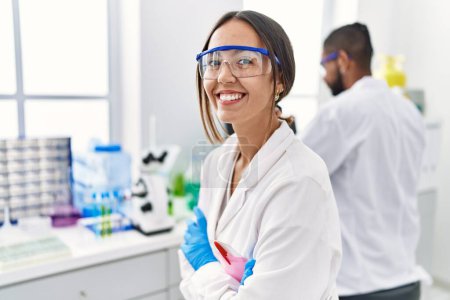 Téléchargez les photos : Man and woman scientist partners smiling confident working at laboratory - en image libre de droit