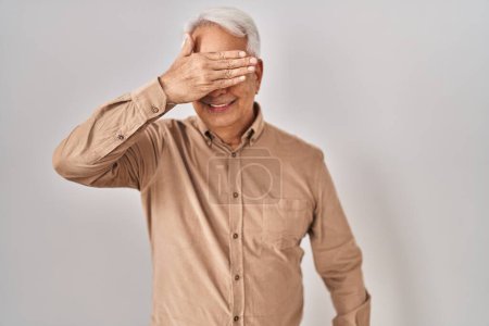 Photo for Hispanic senior man wearing glasses smiling and laughing with hand on face covering eyes for surprise. blind concept. - Royalty Free Image