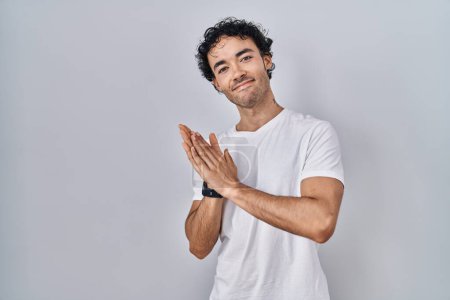 Photo for Hispanic man standing over isolated background clapping and applauding happy and joyful, smiling proud hands together - Royalty Free Image