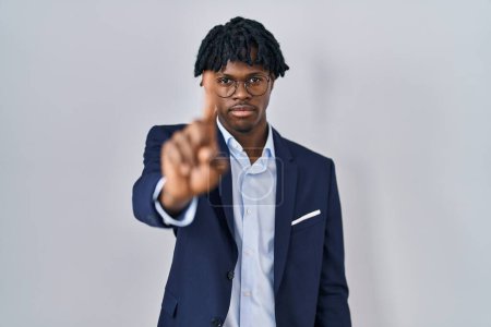 Photo for Young african man with dreadlocks wearing business jacket over white background pointing with finger up and angry expression, showing no gesture - Royalty Free Image