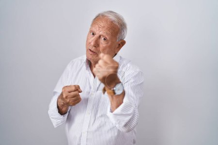 Photo for Senior man with grey hair standing over isolated background ready to fight with fist defense gesture, angry and upset face, afraid of problem - Royalty Free Image