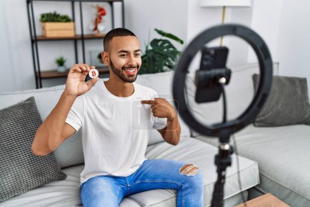 Photo for African american man recording vlog tutorial about bitcoin with smartphone at home pointing finger to one self smiling happy and proud - Royalty Free Image
