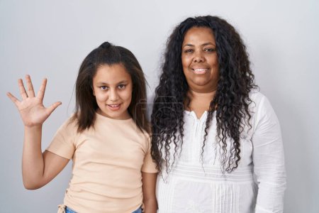 Photo for Mother and young daughter standing over white background showing and pointing up with fingers number five while smiling confident and happy. - Royalty Free Image