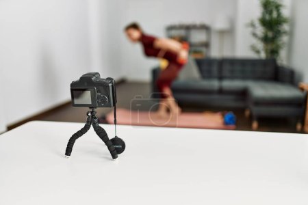 Photo for Middle age caucasian sporty woman doing training tutorial using camera at home. - Royalty Free Image