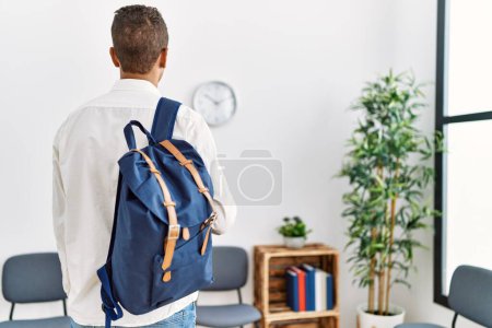 Photo for Young hispanic man waiting with student bag at waiting room - Royalty Free Image