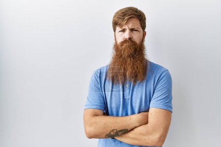 Photo for Caucasian man with long beard standing over isolated background skeptic and nervous, disapproving expression on face with crossed arms. negative person. - Royalty Free Image