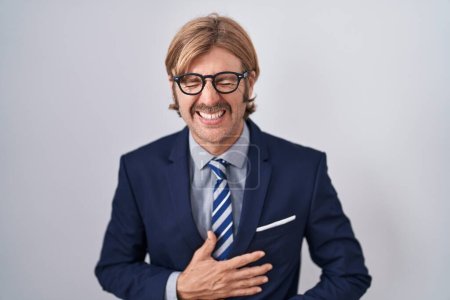 Photo for Caucasian man with mustache wearing business clothes smiling and laughing hard out loud because funny crazy joke with hands on body. - Royalty Free Image