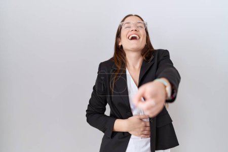 Photo for Beautiful brunette woman wearing business jacket and glasses laughing at you, pointing finger to the camera with hand over body, shame expression - Royalty Free Image