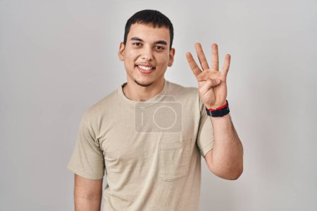 Photo for Young arab man wearing casual t shirt showing and pointing up with fingers number four while smiling confident and happy. - Royalty Free Image