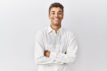 Photo for Young handsome hispanic man standing over isolated background happy face smiling with crossed arms looking at the camera. positive person. - Royalty Free Image