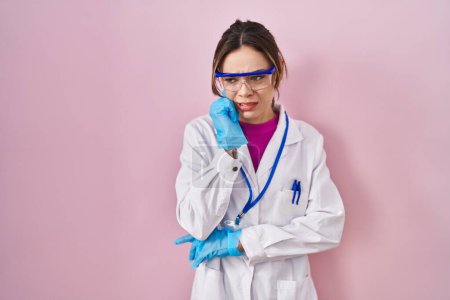 Photo for Hispanic woman wearing scientist uniform looking stressed and nervous with hands on mouth biting nails. anxiety problem. - Royalty Free Image