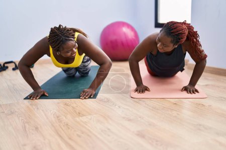 Photo for African american women smiling confident training push up at sport center - Royalty Free Image