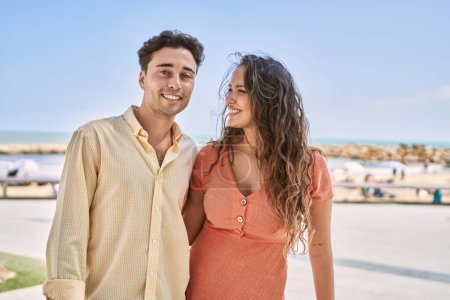 Téléchargez les photos : Man and woman couple smiling confident and hugging each other at seaside - en image libre de droit