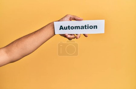 Photo for Hand of caucasian man holding paper with automation word over isolated white background - Royalty Free Image