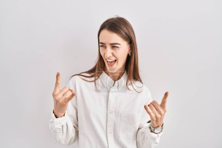 Photo for Young caucasian woman standing over isolated background shouting with crazy expression doing rock symbol with hands up. music star. heavy music concept. - Royalty Free Image