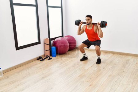 Photo for Young arab man training with dumbbells at sport center - Royalty Free Image