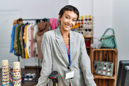 Photo for Young hispanic woman shopkeeper smiling confident working at clothing store - Royalty Free Image