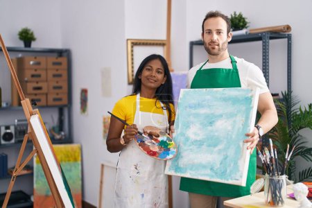 Photo for Man and woman artist couple holding canvas draw at art studio - Royalty Free Image