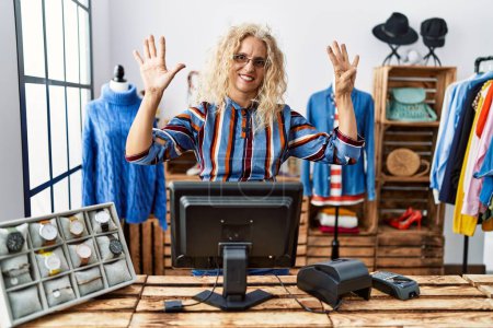 Photo for Middle age blonde woman working as manager at retail boutique showing and pointing up with fingers number nine while smiling confident and happy. - Royalty Free Image