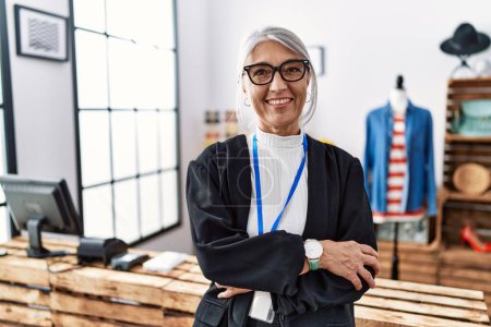 Photo for Middle age grey-haired woman working as manager at retail boutique happy face smiling with crossed arms looking at the camera. positive person. - Royalty Free Image