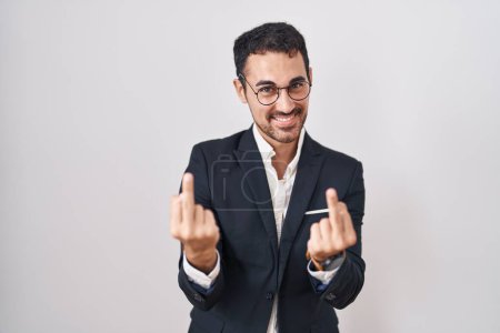 Foto de Handsome business hispanic man standing over white background showing middle finger doing fuck you bad expression, provocation and rude attitude. screaming excited - Imagen libre de derechos