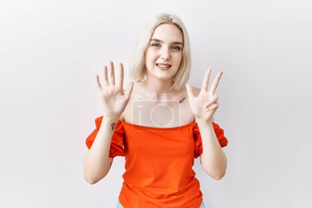 Photo for Young caucasian woman standing over isolated background showing and pointing up with fingers number eight while smiling confident and happy. - Royalty Free Image