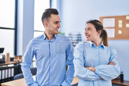 Téléchargez les photos : Man and woman business workers smiling confident standing with arms crossed gesture at office - en image libre de droit
