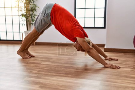 Photo for Young caucasian man stretching at sport center - Royalty Free Image