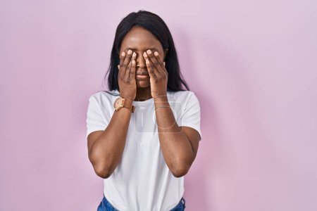 Photo for African young woman wearing casual white t shirt rubbing eyes for fatigue and headache, sleepy and tired expression. vision problem - Royalty Free Image