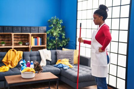 Photo for African american woman cleaner standing at home - Royalty Free Image