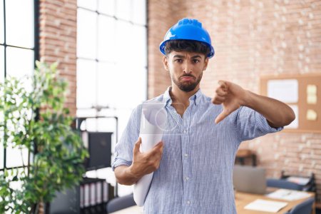 Photo for Arab man with beard wearing architect hardhat at construction office with angry face, negative sign showing dislike with thumbs down, rejection concept - Royalty Free Image