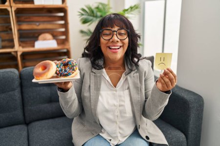 Photo for Hispanic therapist woman working on eating disorder smiling and laughing hard out loud because funny crazy joke. - Royalty Free Image