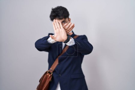 Photo for Hispanic man with beard wearing business clothes rejection expression crossing arms and palms doing negative sign, angry face - Royalty Free Image