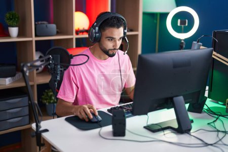Photo for Young arab man streamer playing video game using computer at gaming room - Royalty Free Image