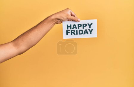 Foto de Hand of caucasian man holding paper with happy friday message over isolated white background - Imagen libre de derechos