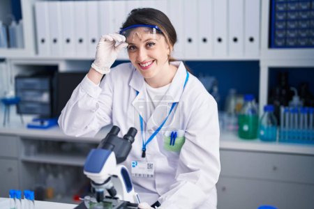 Photo for Young hispanic woman scientist smiling confident working at laboratory - Royalty Free Image