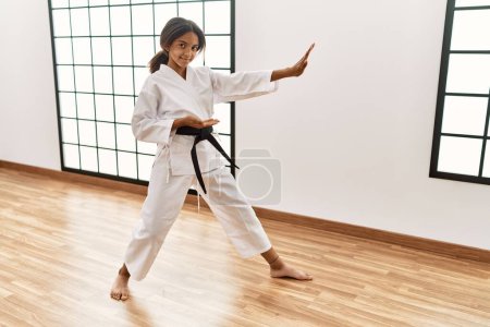 Photo for African american girl wearing kimono training karate at sport center - Royalty Free Image