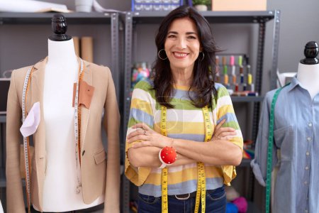 Photo for Middle age hispanic woman tailor smiling confident standing with arms crossed gesture at atelier - Royalty Free Image