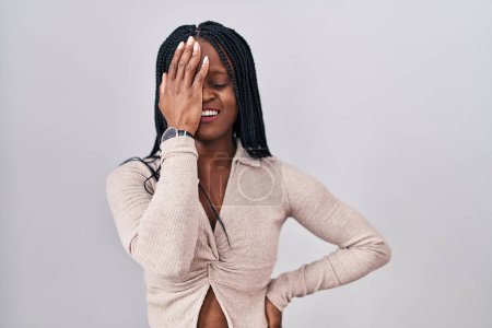 Photo for African woman with braids standing over white background yawning tired covering half face, eye and mouth with hand. face hurts in pain. - Royalty Free Image