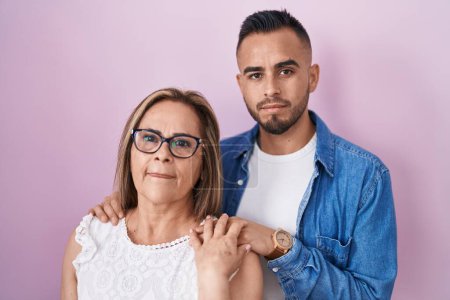 Photo for Hispanic mother and son standing together relaxed with serious expression on face. simple and natural looking at the camera. - Royalty Free Image