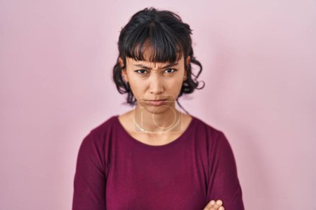 Photo for Young beautiful woman standing over pink background skeptic and nervous, frowning upset because of problem. negative person. - Royalty Free Image