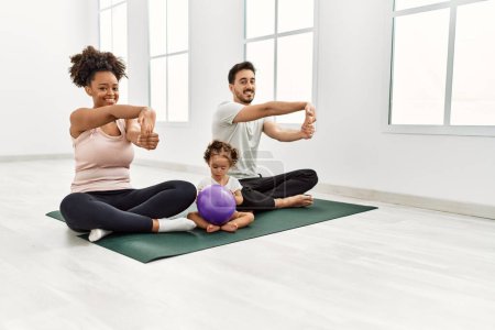 Photo for Couple and daughter smiling confident stretching at sport center - Royalty Free Image