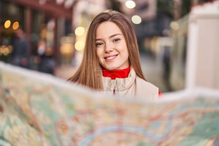 Photo for Young blonde woman smiling confident holding city map at street - Royalty Free Image