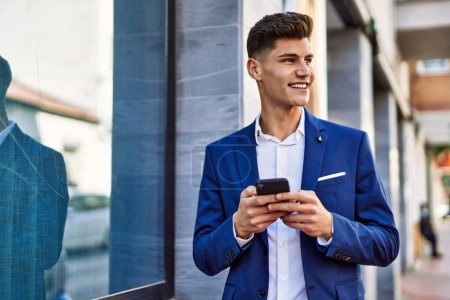Photo for Young man using smartphone wearing suit at street - Royalty Free Image