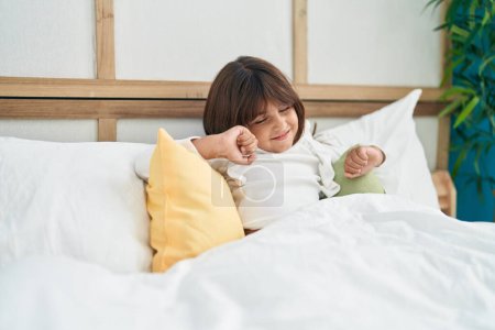Photo for Adorable hispanic girl waking up stretching arms at bedroom - Royalty Free Image