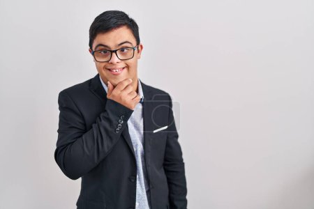 Photo for Young hispanic man with down syndrome wearing business style looking confident at the camera smiling with crossed arms and hand raised on chin. thinking positive. - Royalty Free Image