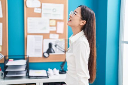 Photo for Young chinese woman business worker smiling confident at office - Royalty Free Image