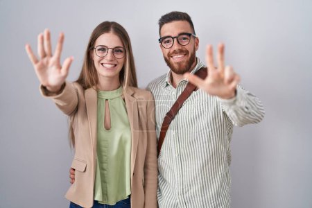 Photo for Young couple standing over white background showing and pointing up with fingers number eight while smiling confident and happy. - Royalty Free Image