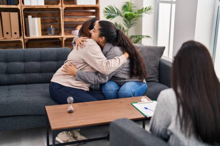 Photo for Three woman mother and daughter hugging each other having psychology therapy at psychology center - Royalty Free Image