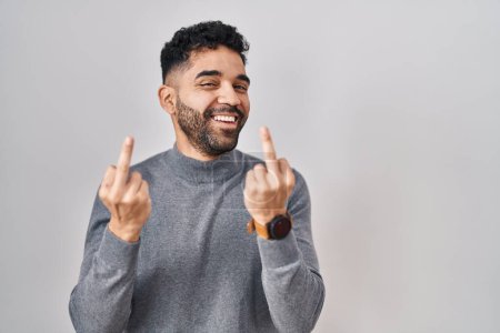 Téléchargez les photos : Hispanic man with beard standing over white background showing middle finger doing fuck you bad expression, provocation and rude attitude. screaming excited - en image libre de droit